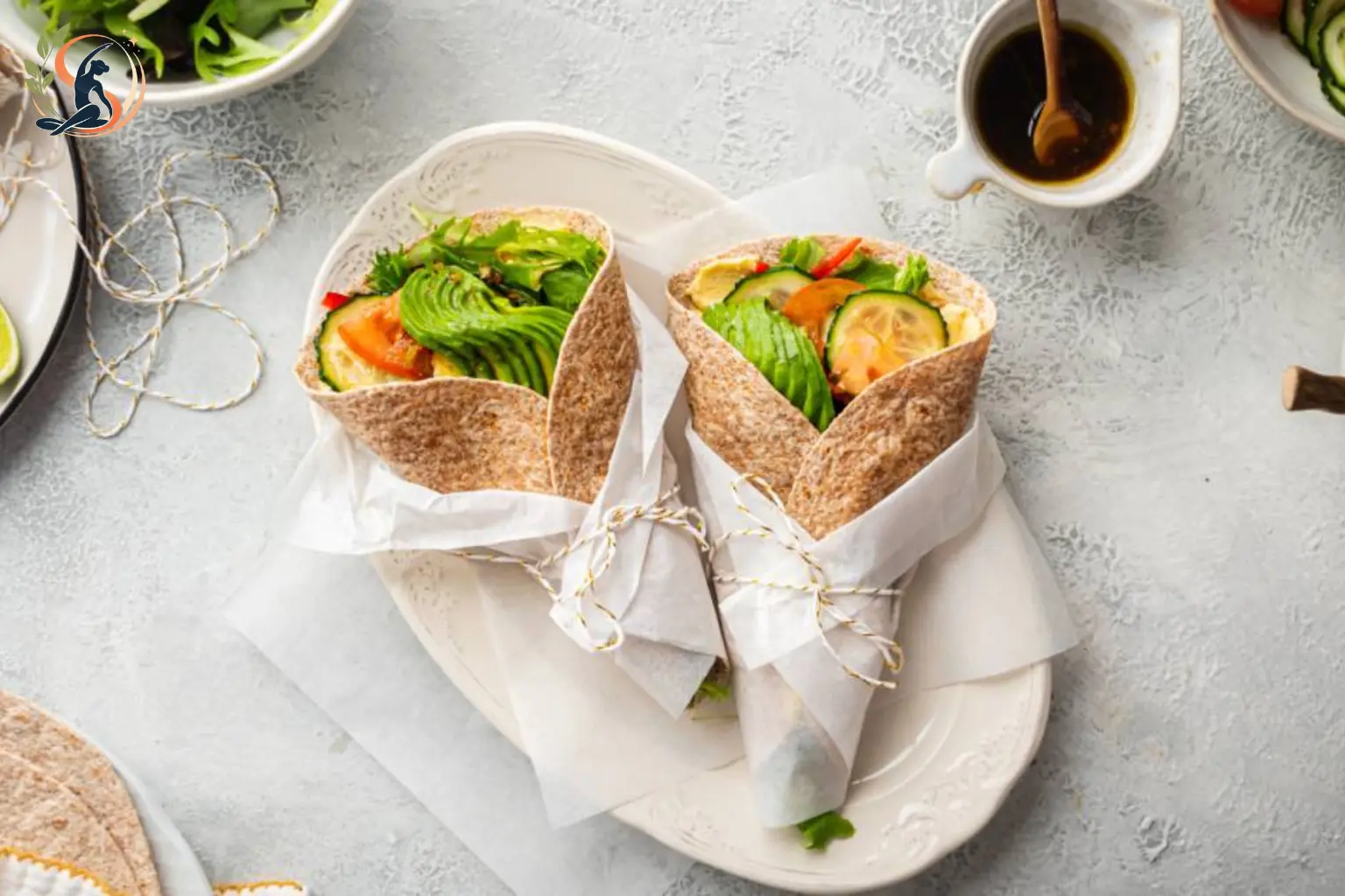 whole wheat hummus wrap filled with fresh vegetables and chickpeas