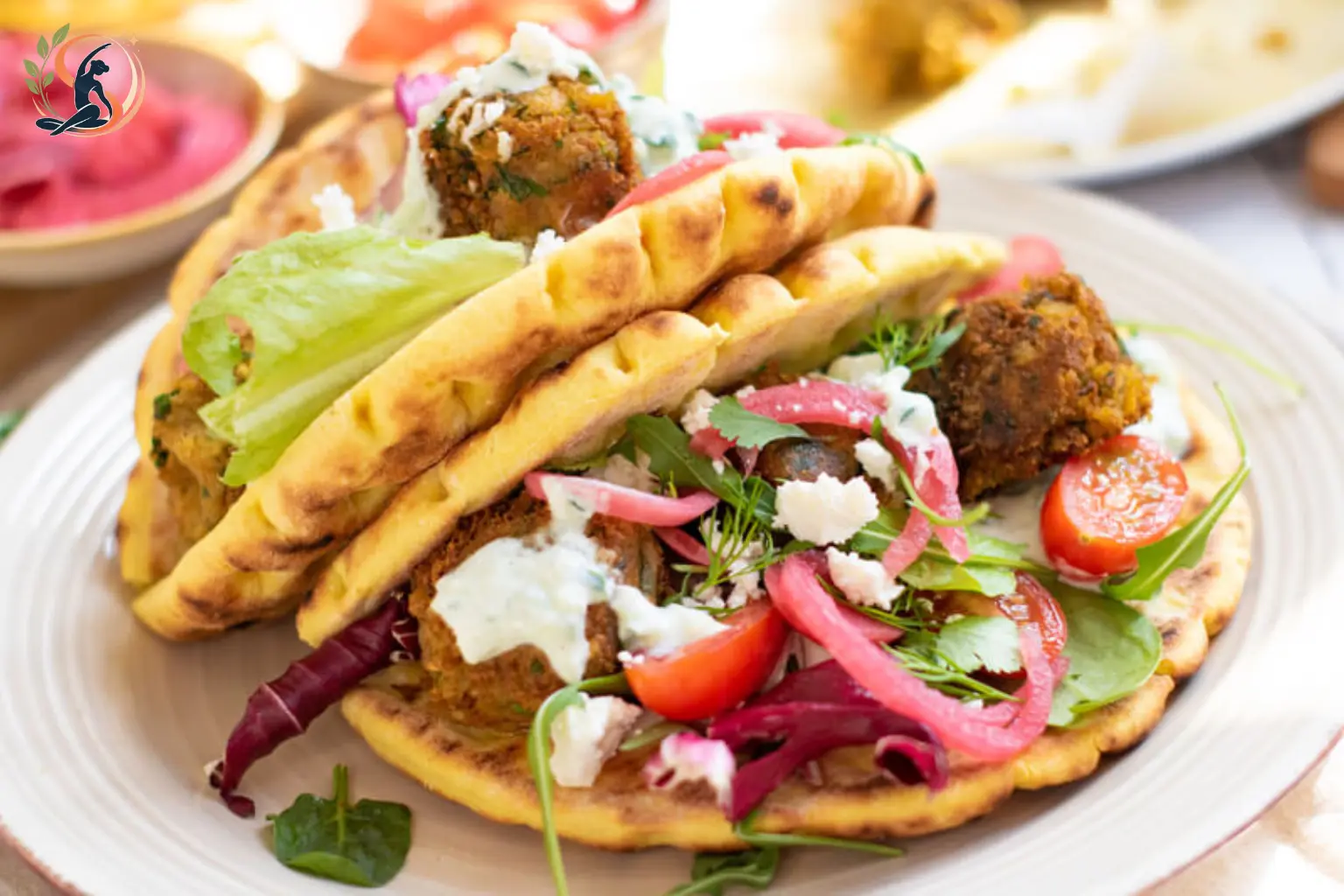 crispy baked falafel wrap with hummus and tzatziki
