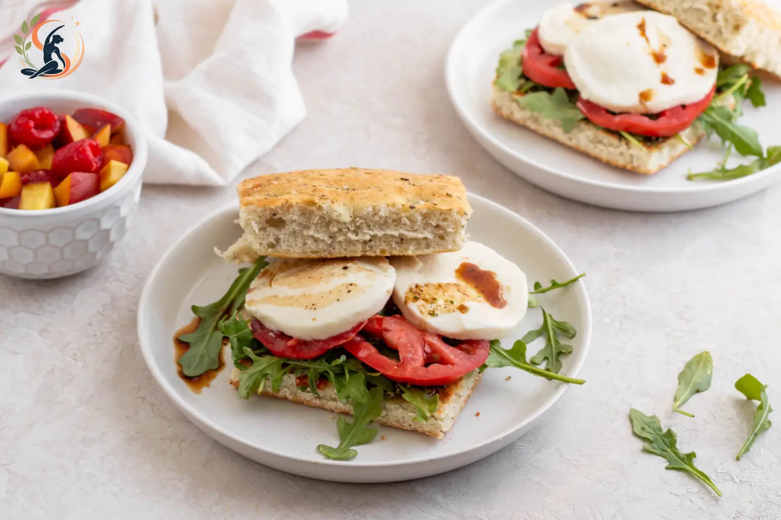 Caprese focaccia sandwich with fresh mozzarella roasted tomatoes basil and balsamic glaze
