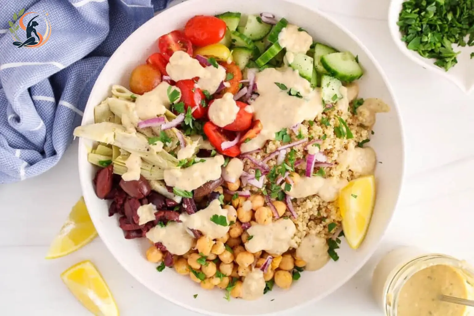 Mediterranean quinoa bowl with roasted tomatoes cucumber olives feta and garlic yogurt sauce